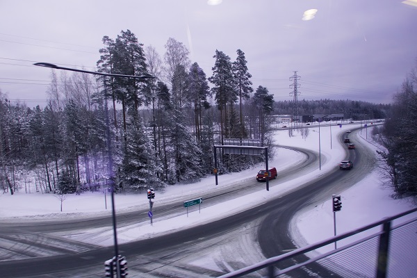 Cars at an intersection on in a snow covered landscape